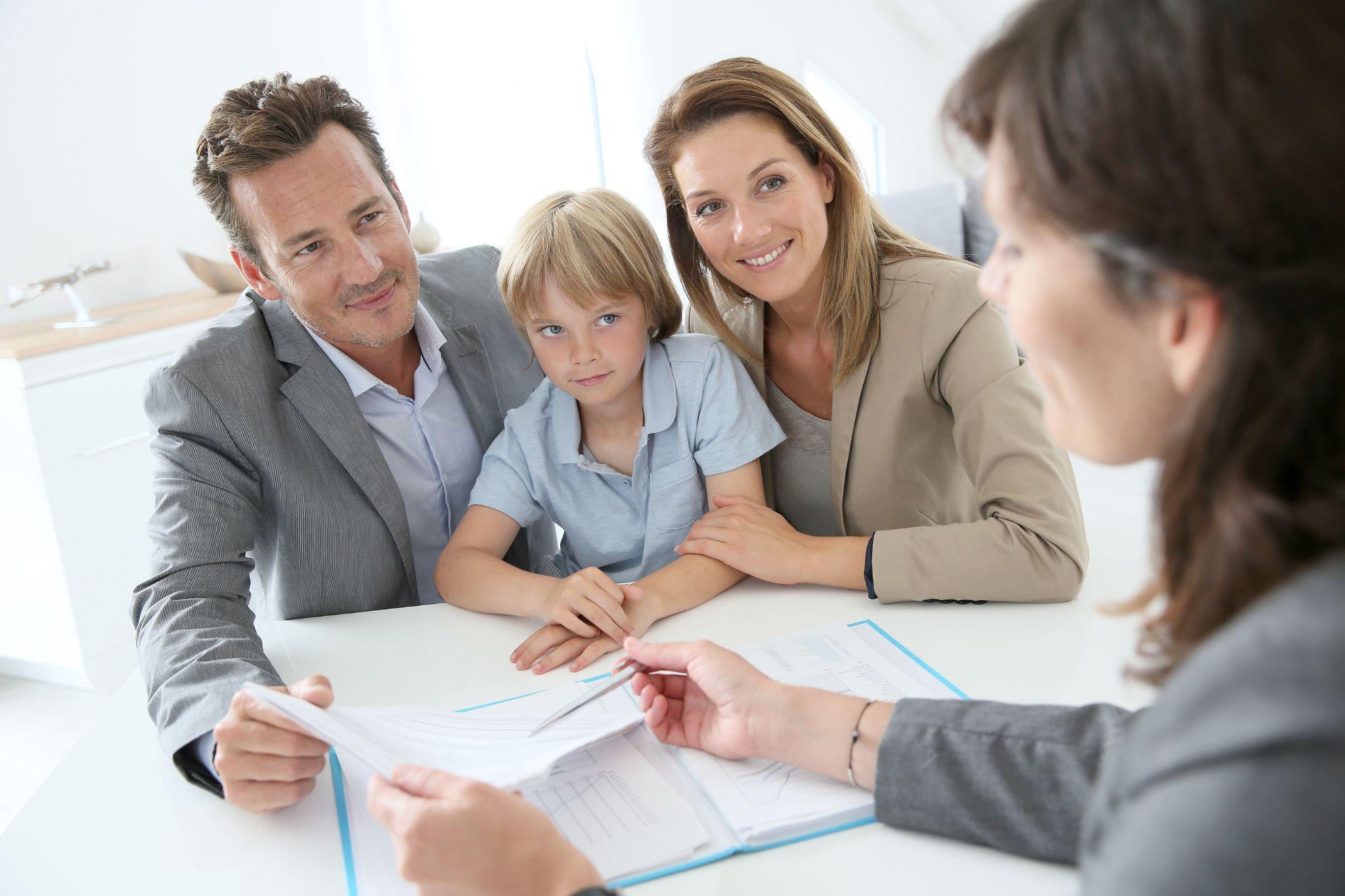 A family meeting with a real estate agent discussing property trust planning to secure family assets and avoid probate