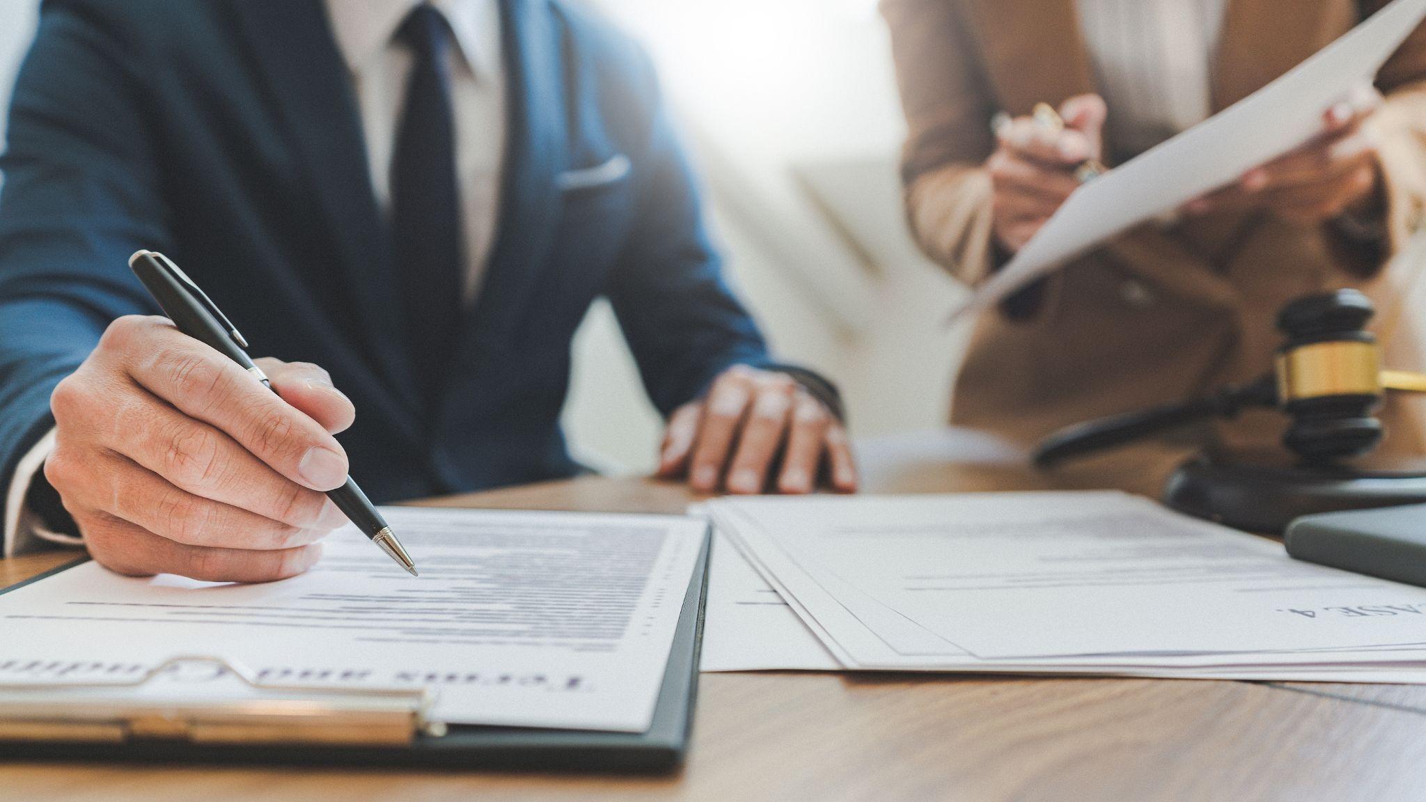 A lawyer in a consultation with a client, focusing on legal documents, possibly related to real estate disputes