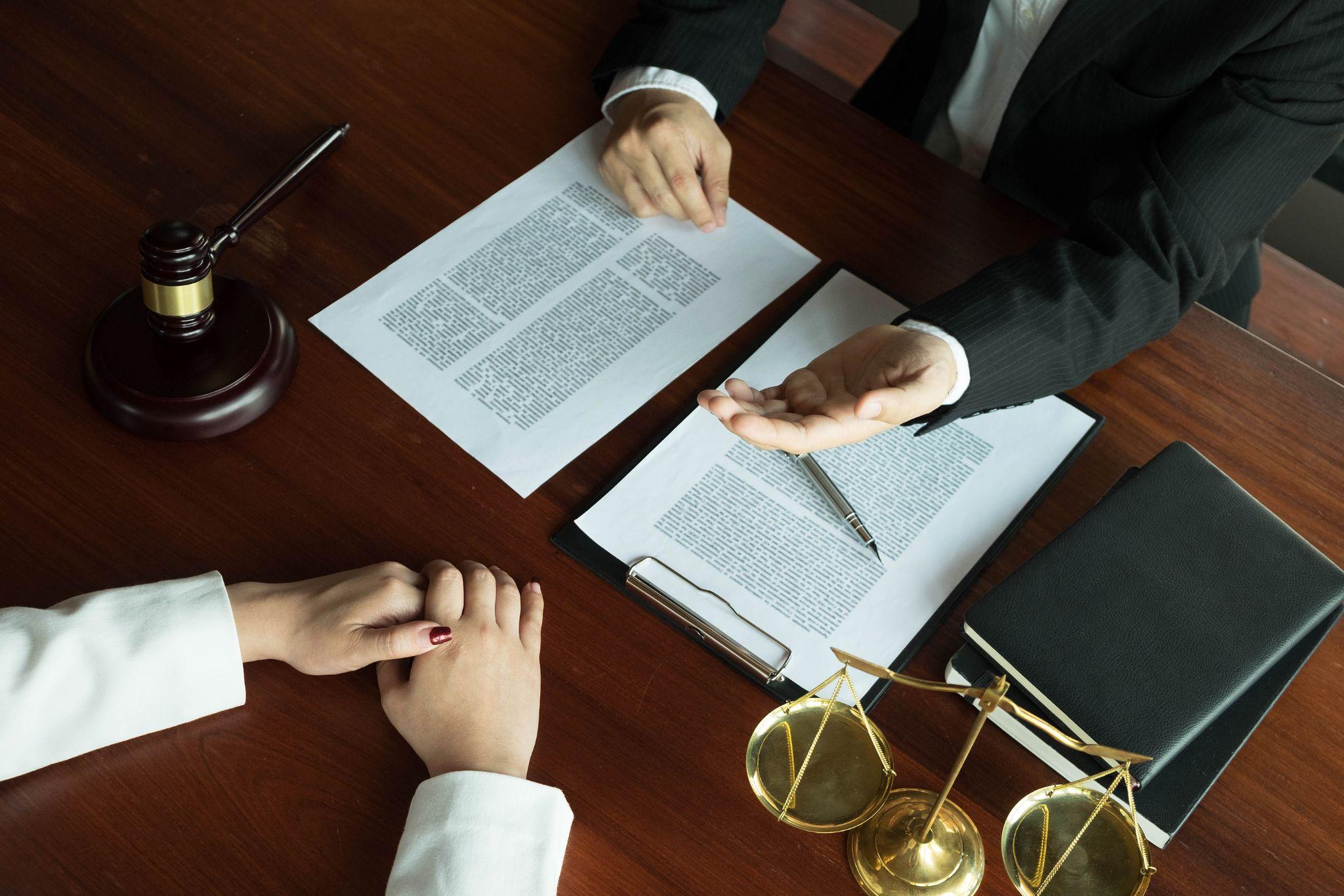 A lawyer discussing a legal contract with a client, emphasizing real estate or property law